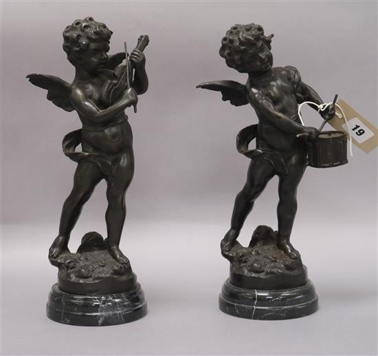 Two bronze sculptures of cherubs playing instruments, on marble bases tallest 32cm